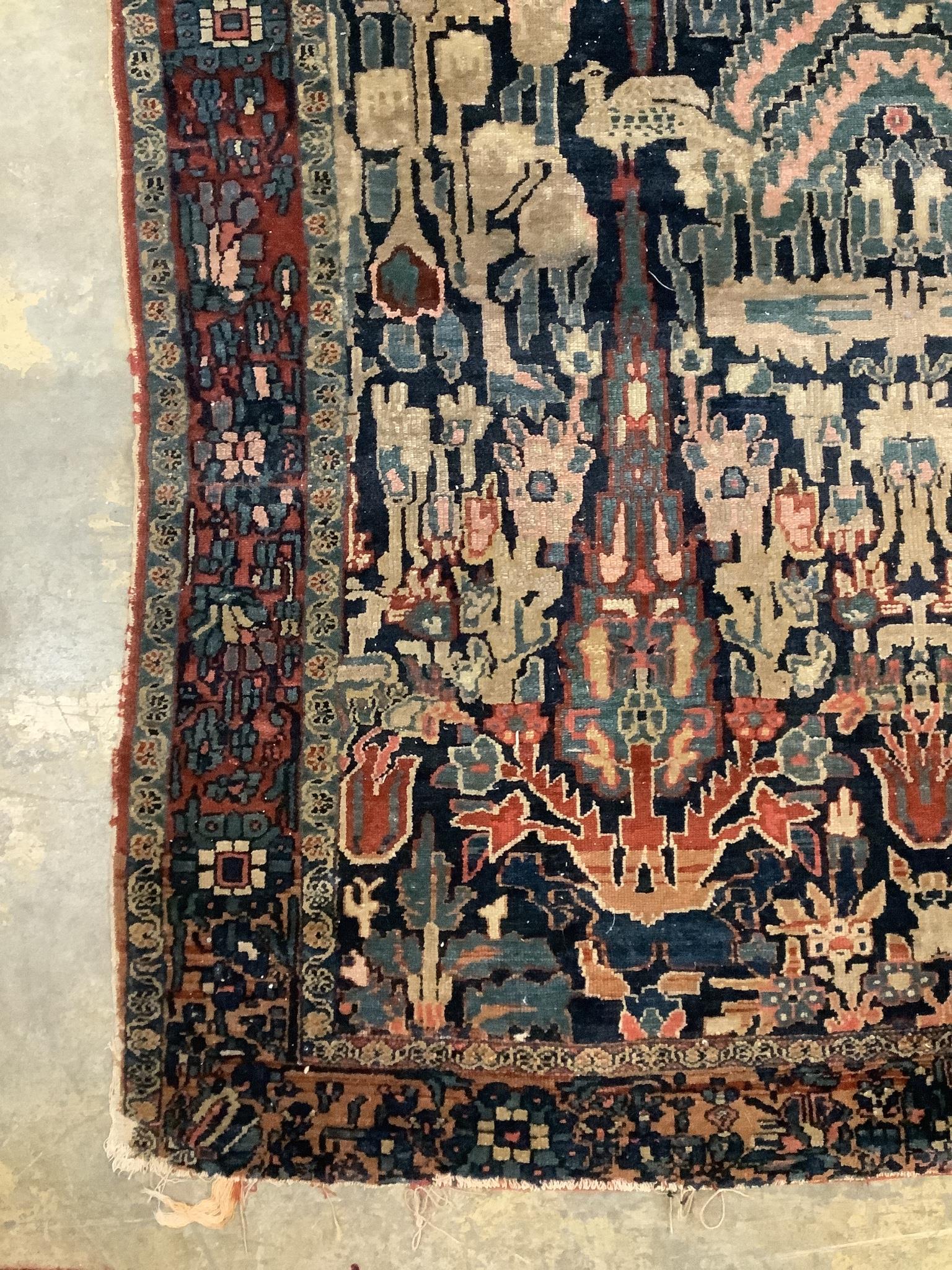 An antique Persian blue ground rug, woven with birds within a garden, 170 x 120cm